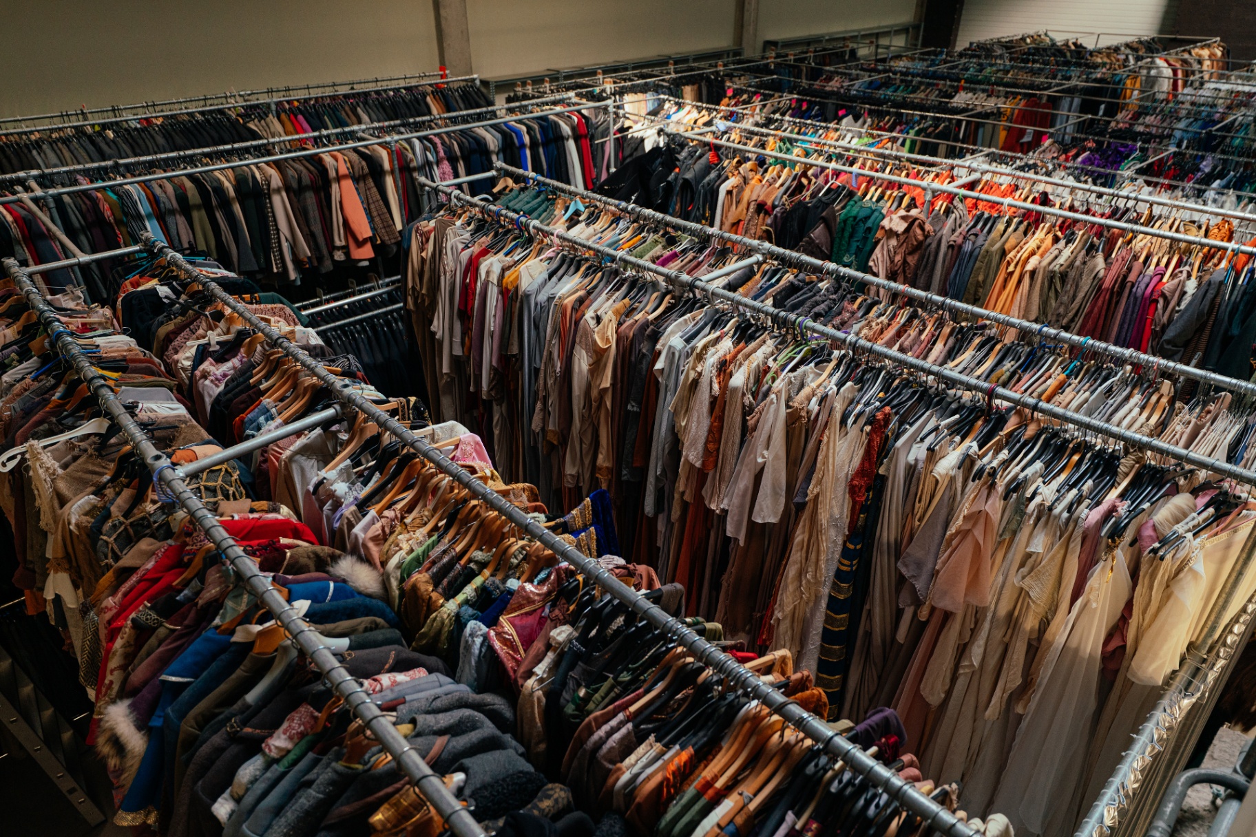 Large costume rental archive with dense racks of garments