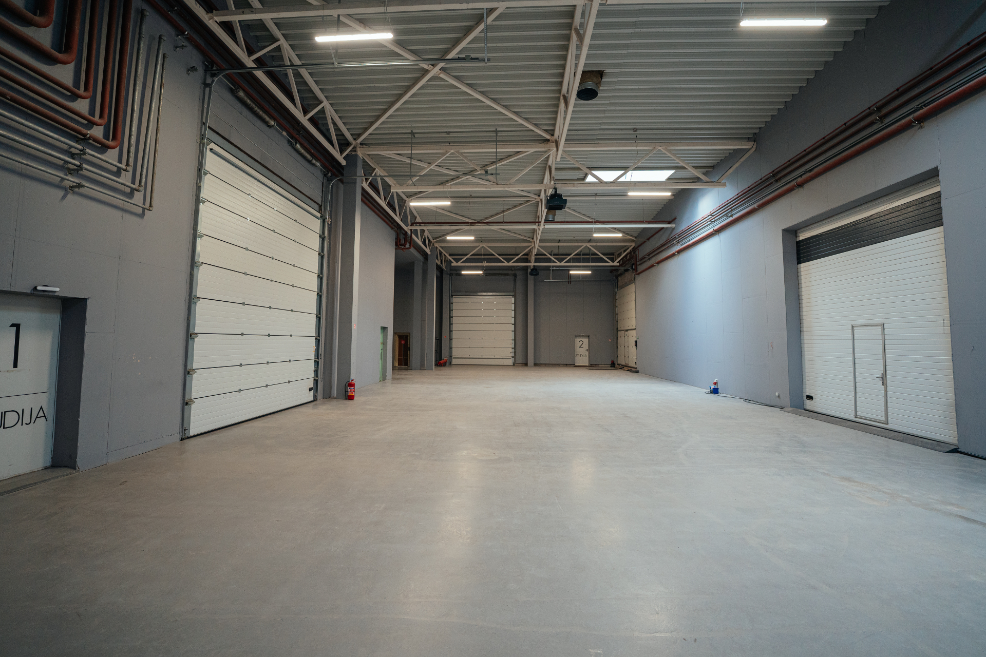 Large interior lobby with tall roller doors and drive-in access