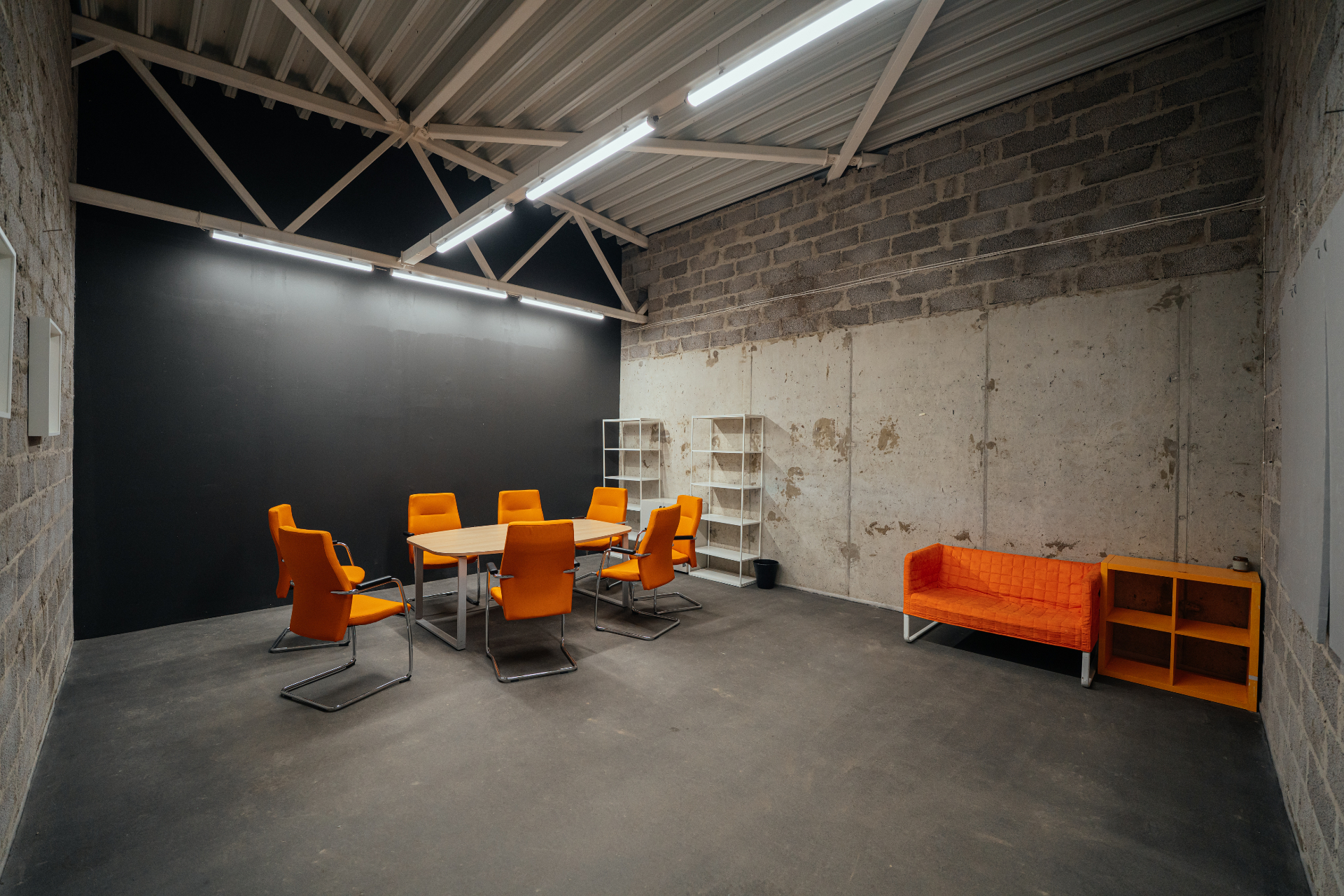 Second floor production meeting room with orange chairs