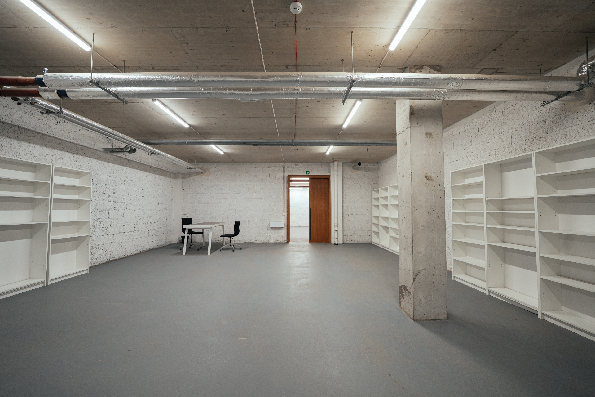 First floor production area with white shelving and open floor